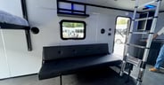 A couch is available and the ladder provides access to the loft in the Continental Cargo Trailers Weekender