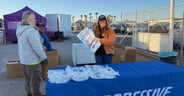 Kimmy King hands out welcome packets on opening day