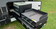 The slide-out kitchen with 12 volt cooler in the Palomino Pause XC 20.3 travel trailer