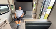 The couch features a fold-down armrest