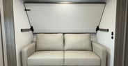 A jackknife sofa with overhead drop-down berth in the Grand Desi