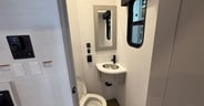 The second bathroom off the cargo area has a sink and toilet.