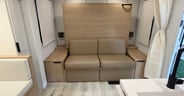 A Murphy bed offers a couch by day in the Winnebago Thrive 22MBH