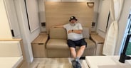 A couch offers a place to sit by day in the Winnebago Thrive 22M