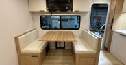 A four-place dinette with good camp-side window coverage in the
