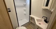 A good bathroom with a Nautilus shower door and fiberglass count