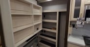 A large spacious pantry behind the TV and fireplace in the Cedar