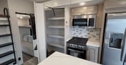 A pantry hidden behind the TV in the Highland Ridge Open Range 3
