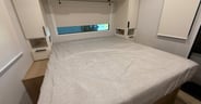 An Olympic queen mattress in the bedroom of the Thrive 24RKS
