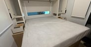 Closets and a drawer plus night stands in the bedroom of the Thr