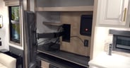 More storage behind the TV which swings out for viewing