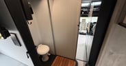 The folding shower door follows a track to enclose the shower