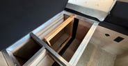 The hanging closet system tucks under the camp-side bed in the G