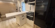 The kitchen features a flush counter extension and fiberglass co
