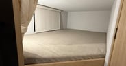 The lower bunk in the Winnebago Thrive 22MBH