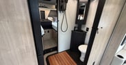 Two articulated doors on tracks enclose the bathroom of the Gran
