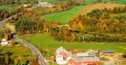 Aerial view of farm near Stowe, VT in autumn on Scenic Route 100