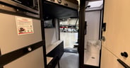 The large cargo bay at the back of the RV with the drop-down ramp