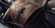 Close-up of Brown Leather Motorcycle Saddlebag with Metal Buckle