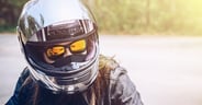Confidence Asian woman wearing a motorcycle helmet before riding