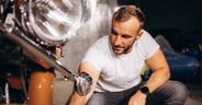 A man washes his retro motorcycle